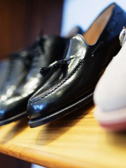 Formal shoes arranged in shelf at clothing store